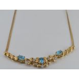 A 9ct gold necklace set with blue topaz and diamonds, 7.5g