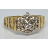 An 18ct gold ring set with diamonds in a cluster, 4.4g, size L/M