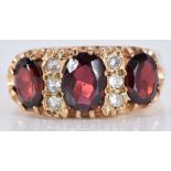 A 9ct gold ring set with three oval garnets and cubic zirconia, 5.0g, size Q/R