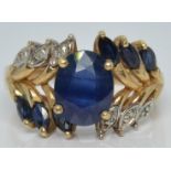 A 10k gold ring set with an oval sapphire, marquise cut sapphires and diamonds, 4.8g, size Q