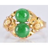 A 14k gold ring set with two jade cabochons with floral embossed shoulders, 3.1g, size O