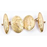 A pair of 15ct gold cufflinks with engraved foliate decoration, 8.3g