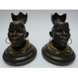 Pair of Goldscheider Wien bronze and gilt metal African head inkwells with hinged lids, on