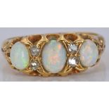 An 18ct gold ring set with opals and diamonds, 4.3g, size I