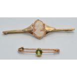 A 9ct gold brooch set with a peridot and a 9ct brooch set with a cameo, 5.3g