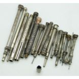 Eighteen white metal and similar propelling pencils, most with engraved detail, largest 9.5cm long