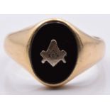 A yellow metal ring set with onyx and a Masonic symbol, 3.4g, size R