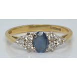 An 18ct gold ring set with a sapphire and six diamonds, 2.3g, size L