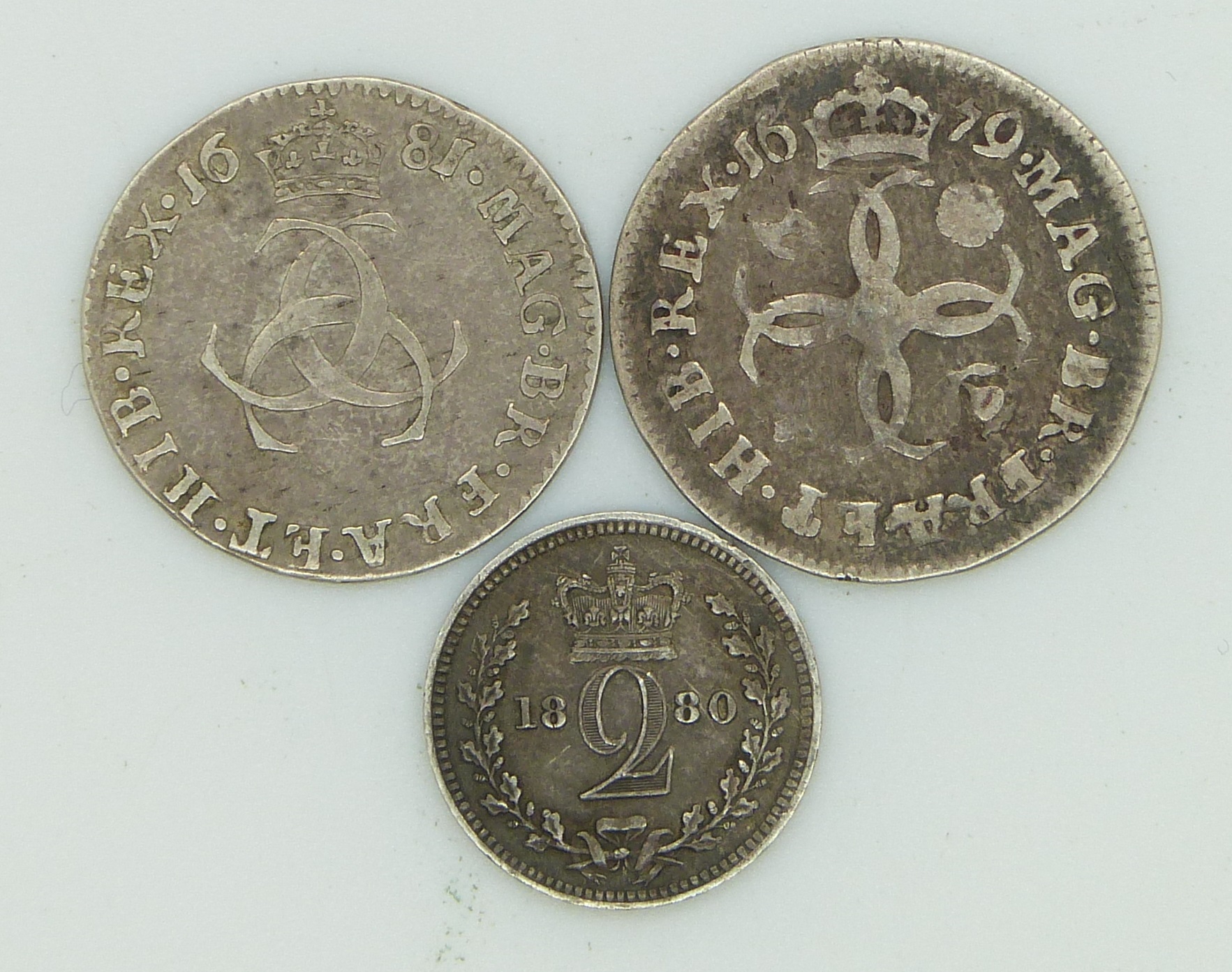 1679 Charles II Maundy fourpence together with a 1681 Maundy threepence and an 1880 Queen Victoria