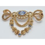 A 9ct gold brooch set with an oval sapphire surrounded by seed pearls and three other sapphires, 3 x