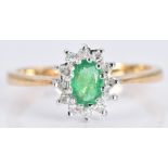An 18ct gold ring set with an emerald and diamonds, 2.7g, size L