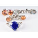 A silver ring set with a pear cut lapis lazuli and zircons and three pairs of silver earrings set