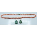 A beaded coral necklace and a pair of turquoise earrings