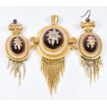 Etruscan Revival pendant set in turn with a foiled garnet cabochon set with old cut diamonds in a