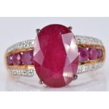 A 9ct gold ring set with a large oval ruby and diamonds, with three round cut rubies to each