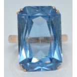 A 14k gold ring set with a large emerald cut blue topaz, 8.3g, size R