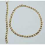 A 14ct bi-coloured gold necklace and bracelet made up of foliate links, 34g