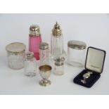 Six various hallmarked silver lidded cut glass items including a cranberry glass sugar sifter,