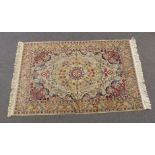 A wool rug with floral decoration on a beige ground, 200 x 125cm
