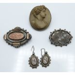 A silver brooch set with a lava cameo (18.8g) , two Victorian silver brooches and a pair of silver