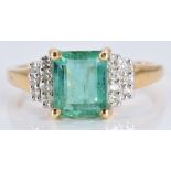 An 18ct gold ring set with an emerald cut emerald and diamonds, 3.5g, size N