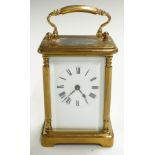 Brass carriage clock with Roman enamelled dial and decorative pillars to corners of case, H11cm