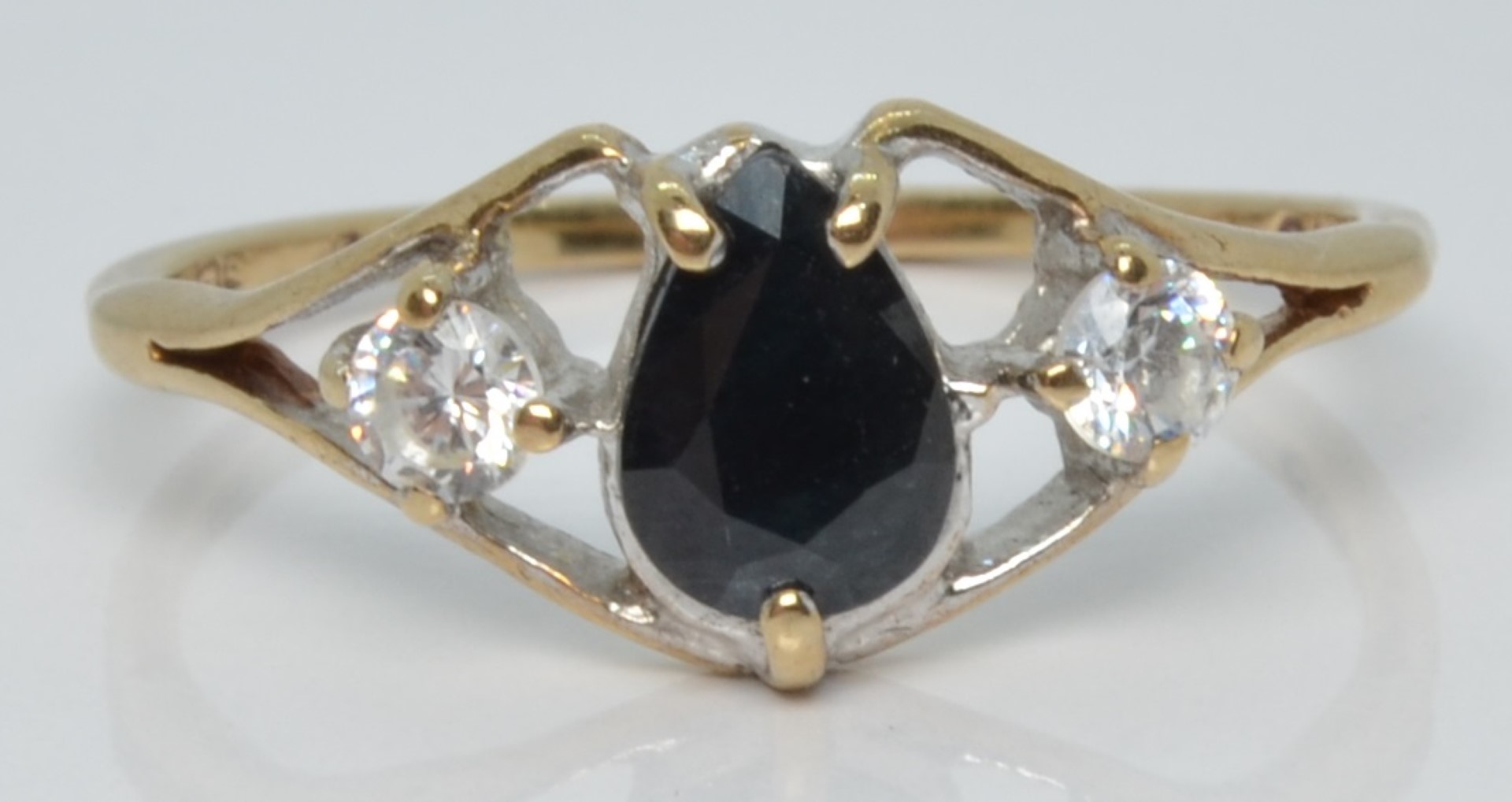 A 9ct gold ring set with a pear cut sapphire and cubic zirconia, 1.9g, size R
