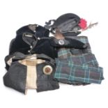 A collection of Scottish dress including several kilts, waistcoats, hats with Scottish badges etc,
