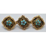 Victorian brooch set with three turquoise clusters on a black enamel ground within a foliate gold