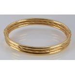 A 9ct gold three band bangle, 8.7g