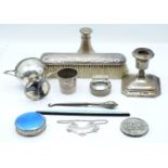 A collection of hallmarked silver items including a candlestick, Birmingham 1927, 1955 silver