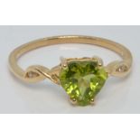 A 10k gold ring set with a heart cut peridot and white zircon, with certificate, size U