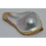 A 9ct gold brooch set with a large abstract pearl, 3 x 4.7cm