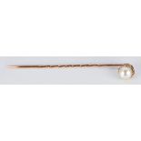 A 9ct rose gold stick pin set with a pearl, in vintage box