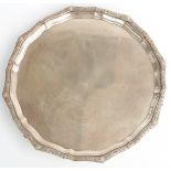 George V hallmarked silver salver with shaped edge, raised on three feet, Birmingham 1934 maker Adie