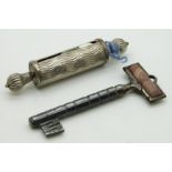 A 19thC steel needle case in the form of a key with agate finial and a tape measure, longest 9cm