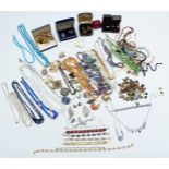 A large collection of costume jewellery including beaded necklaces, brooches, bracelets, vintage