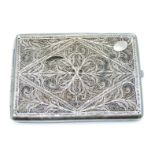 White metal filigree cigarette case with scrolling design, no visible silver marks, width 10.5cm,
