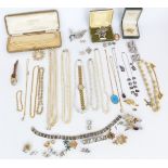 A collection of costume jewellery including vintage brooches, paste buckles, vintage watches,