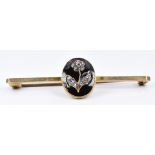 A late Victorian 9ct gold brooch set with black enamel and diamonds in the form of a flower