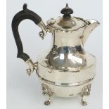 George V hallmarked silver teapot raised on pad feet with lion mask decoration, London 1928, maker