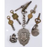Five pocket watch keys, one Bakers Gloucester, a silver fob, and a silver brooch