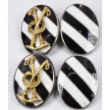 A pair of silver Asprey cufflinks set with black and white enamel with applied gold mallets and