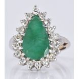 An 18ct white gold ring set with a pear cut emerald surrounded by diamonds, 5.7g, size L