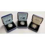 Two Royal Mint 1986 £2 silver proof coins, together with a 1992-93 silver proof 50p, all cased