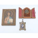 Three icons/ reliquaries including a porcelain portrait miniature plaque in brass easel frame and