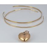 Two 9ct gold bangles 5.1g and a 9ct gold back and front heart locket
