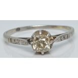 An 18ct white gold ring set with an old cut diamond of approximately 0.3ct and further diamonds to