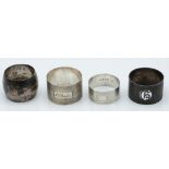 Four various hallmarked silver napkin rings, three having plain engine turned decoration, weight