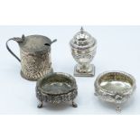 Pair of Victorian hallmarked silver open salts with embossed decoration, raised on three hoof